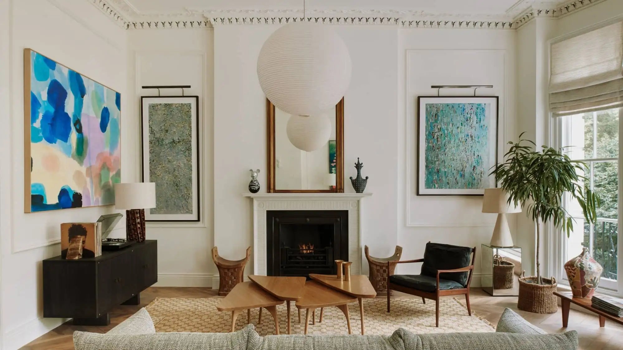 White spherical paper pendant light hanging above the fireplace